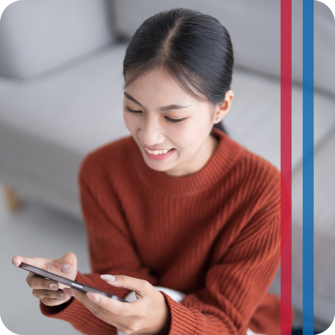 woman using smart thermostat on phone