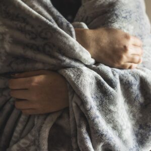 person cold wrapped in a blanket